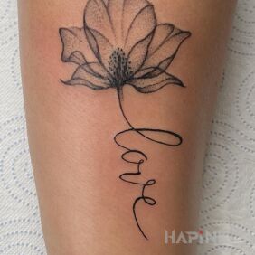 Tattoo Flower with LOVE inscription on the forearm motif: black and gray style: graphic / illustrative