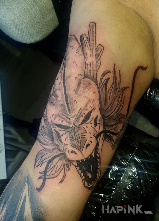 Tattoo Shen Long in dragons motif and cartoon / comic book style on the bicep