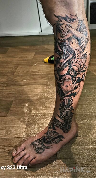 Tattoo Biomechamnika in motorization motif and biomechanics style on the foot