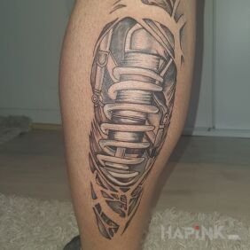 Tattoo Mechanics on the calf motif: black and gray style: biomechanics