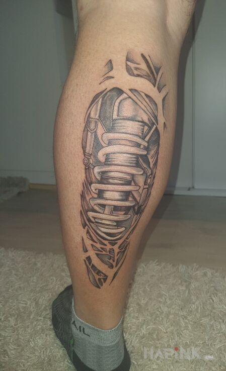Tattoo Mechanika in motorization motif and biomechanics style on the leg