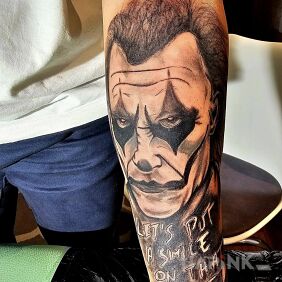 Tattoo Joker on the forearm motif: black and gray style: realistic