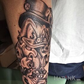 Tattoo Scrooge On the arm motif: characters style: cartoon / comic book