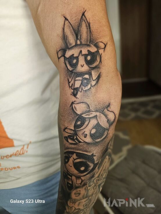 Tattoo Atomówki in characters motif and cartoon / comic book style On the arm