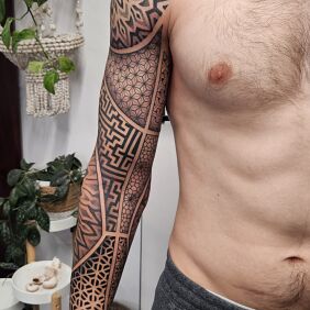 Tattoo Dotwork geometry sleeve on the upper arm motif: ornaments style: dotwork
