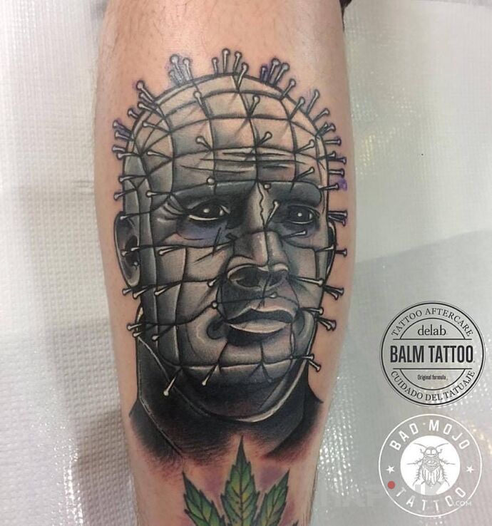 Tattoo Pinhead in demons motif on the calf