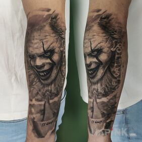 Tattoo Pennywise On the arm motif: dark style: realistic