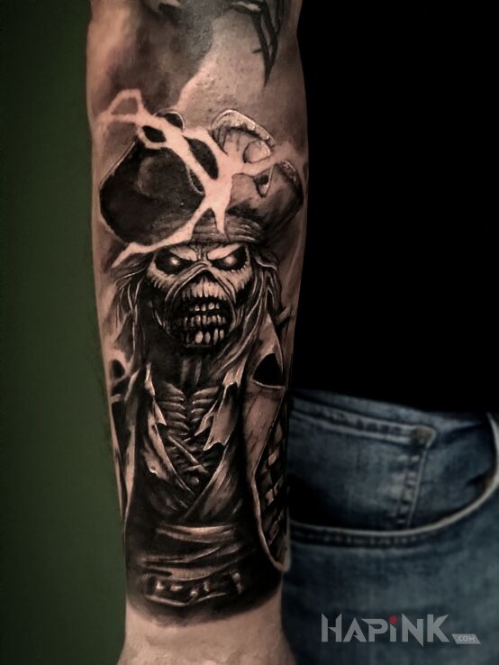 Tattoo Eddie in demons motif and realistic style on the forearm