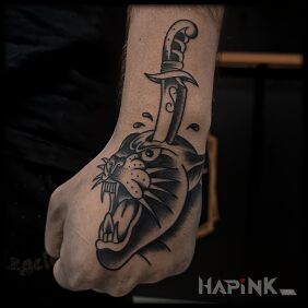 Tattoo Panther with a dagger stabbed on the hand motif: animals style: oldschool