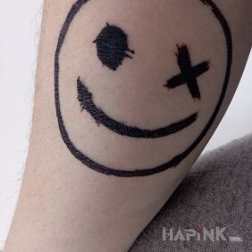 Tattoo Emoji On the arm motif: black and gray style: graphic / illustrative