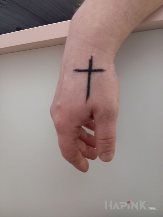 Tattoo Krzyż in black and gray motif and minimalistic style on the hand