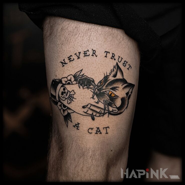 Tattoo Never trust a cat in lettering motif and oldschool style on the leg