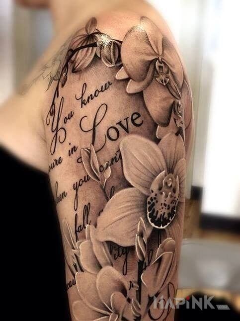 Tattoo Miłość in flowers motif on the upper arm