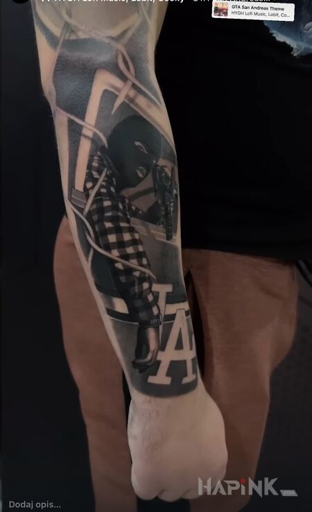 Tattoo Gangster in black and gray motif and chicano style on the forearm