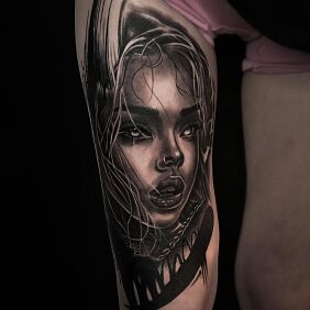 Tattoo Feminine portrait in shades of gray on the leg motif: black and gray style: realistic