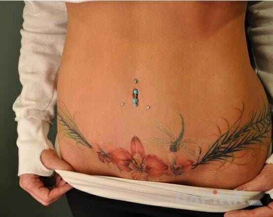 Tattoo Kwiatuszek in sexy motif and realistic style on the stomach