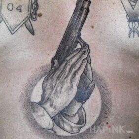 Tattoo Hands holding a gun on the chest motif: objects style: realistic