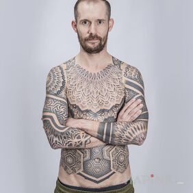 Tattoo Client in a geometric suit On the arm motif: mandalas style: geometric