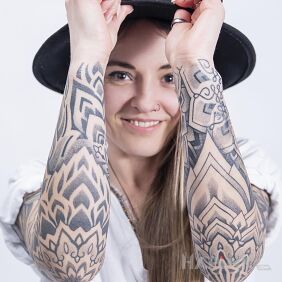 Tattoo Smiling client and her tattooed hands On the arm motif: ornaments style: dotwork