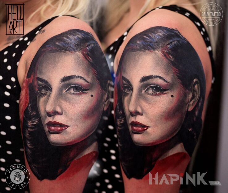 Tattoo Praca Eleny in faces motif and realistic style on the upper arm