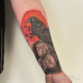 Tattoo Raven on an orange background on the forearm motif: colorful style: realistic