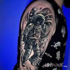 Tattoo Astronaut with a cup on the upper arm motif: funny style: surrealistic