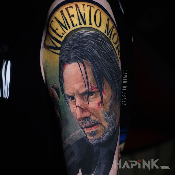 Tattoo John Wick in lettering motif and realistic style On the arm