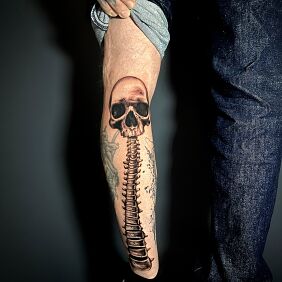 Tattoo Skull with spine on the calf motif: skulls style: realistic