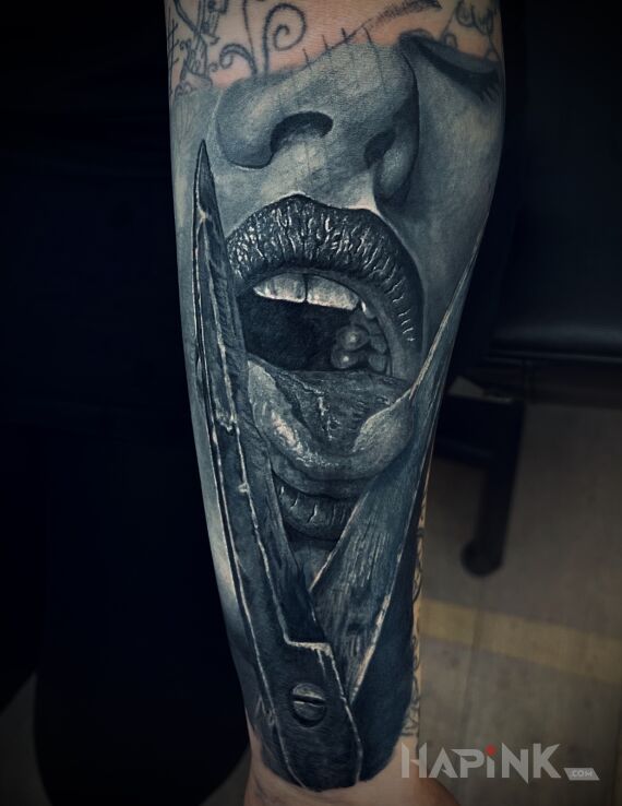 Tattoo Język w nożycach in objects motif and realistic style on the forearm