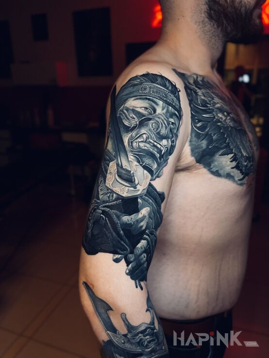 Tattoo Samuraj w masce in black and gray motif and realistic style On the arm