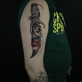 Tattoo Woman trapped in a dagger on the upper arm motif: objects style: graphic / illustrative