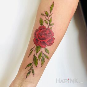 Tattoo Rose with vivid green leaves On the arm motif: flowers style: graphic / illustrative