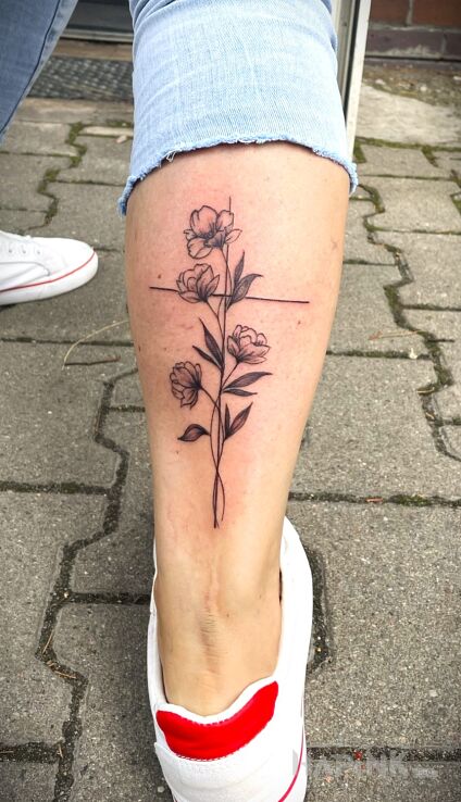 Tattoo Flowers growing along the cross in flowers motif and graphic / illustrative style on the leg