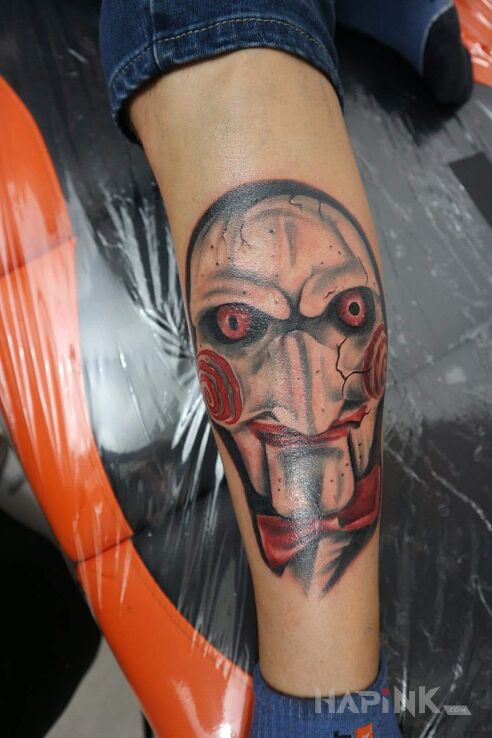 Tattoo Jigsaw in characters motif on the calf