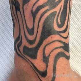Tattoo Rings on the forearm motif: black and gray style: carved wood