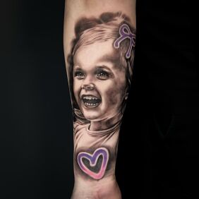 Tattoo Smiling girl on the forearm motif: black and gray style: realistic