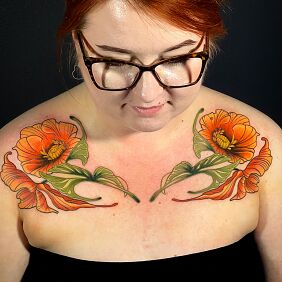 Tattoo Flowers in intense orange color on the chest motif: colorful style: neo-traditional