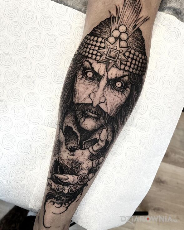 Tattoo Vlad Palownik Dracula in black and gray motif and graphic / illustrative style on the calf