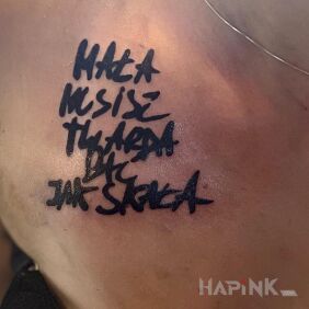 Tattoo Rapper's quote transferred from a piece of paper to the skin on the chest motif: black and gray style: calligraphy