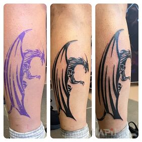Tattoo Dragon in tribal on the leg motif: dragons style: blackwork / blackout