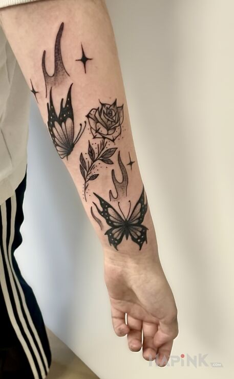 Tattoo Butterflies with a rose in butterflies motif and graphic / illustrative style on the forearm