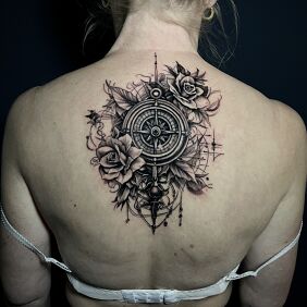 Tattoo Compass lying among the roses on the back motif: objects style: realistic
