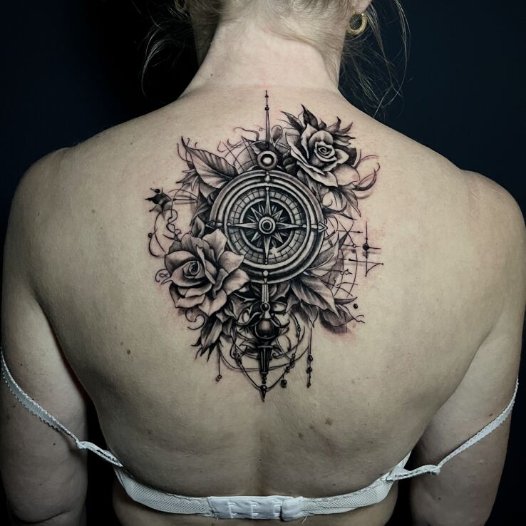 Tattoo Compass flowers leaves back in flowers motif and realistic style on the back