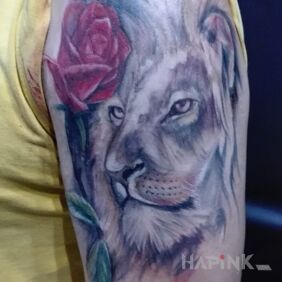 Tattoo The lion and the rose on the upper arm motif: zodiac signs
