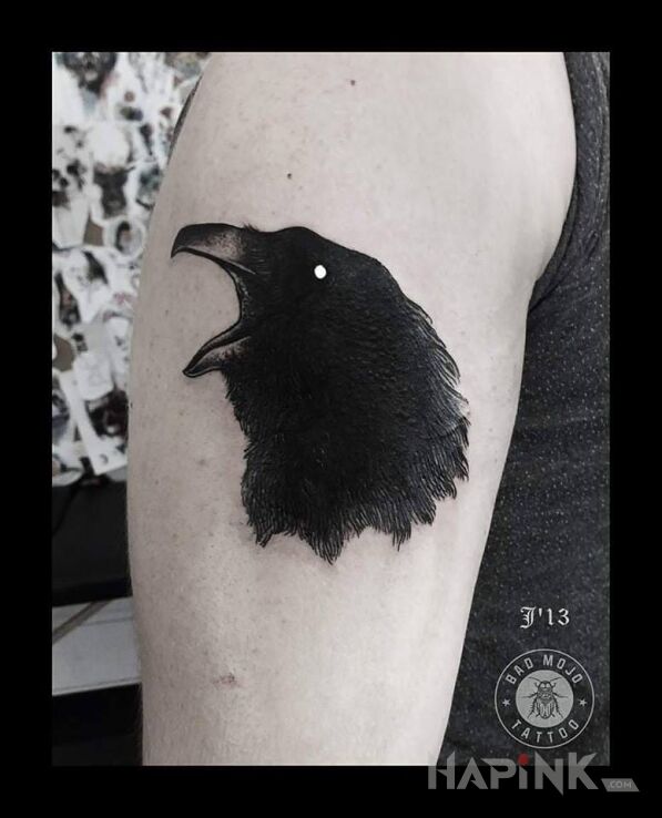 Tattoo Kruk in animals motif on the upper arm