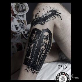 Tattoo Coffin on the calf motif: skulls