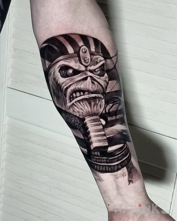Tattoo Eddie in demons motif and graphic / illustrative style On the arm