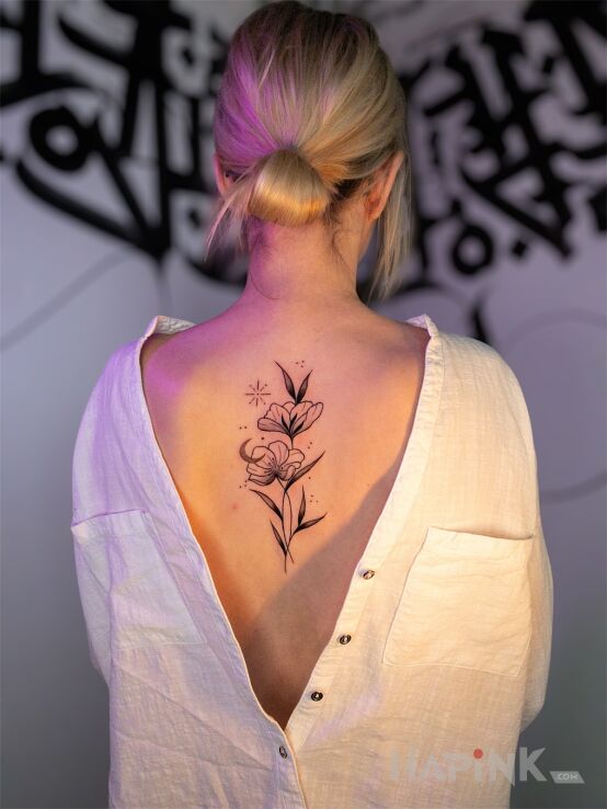 Tattoo Delicate women's floral composition in flowers motif and graphic / illustrative style on the back