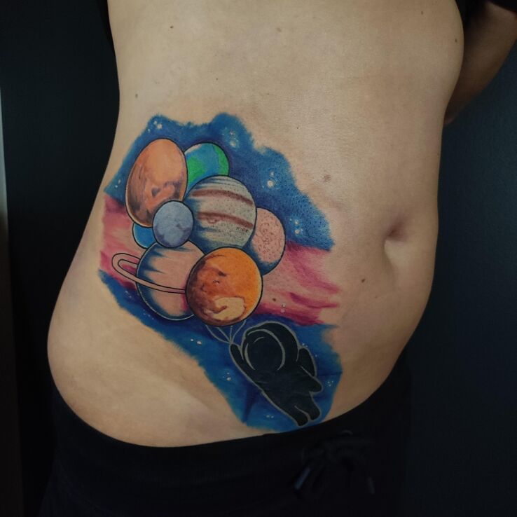 Tattoo Cosmos planets cosmonaut color cover-up in colorful motif and graphic / illustrative style on the stomach