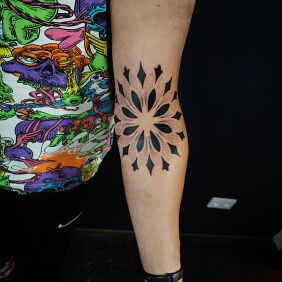Tattoo Black mandala on the bend of the elbow on the forearm motif: black and gray style: dotwork